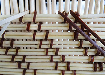 Pink flower in front of swirling statue