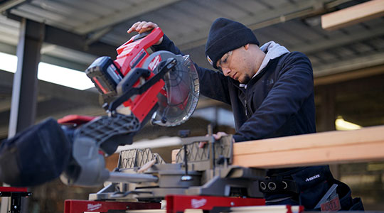 Student cutting wood with a table saw