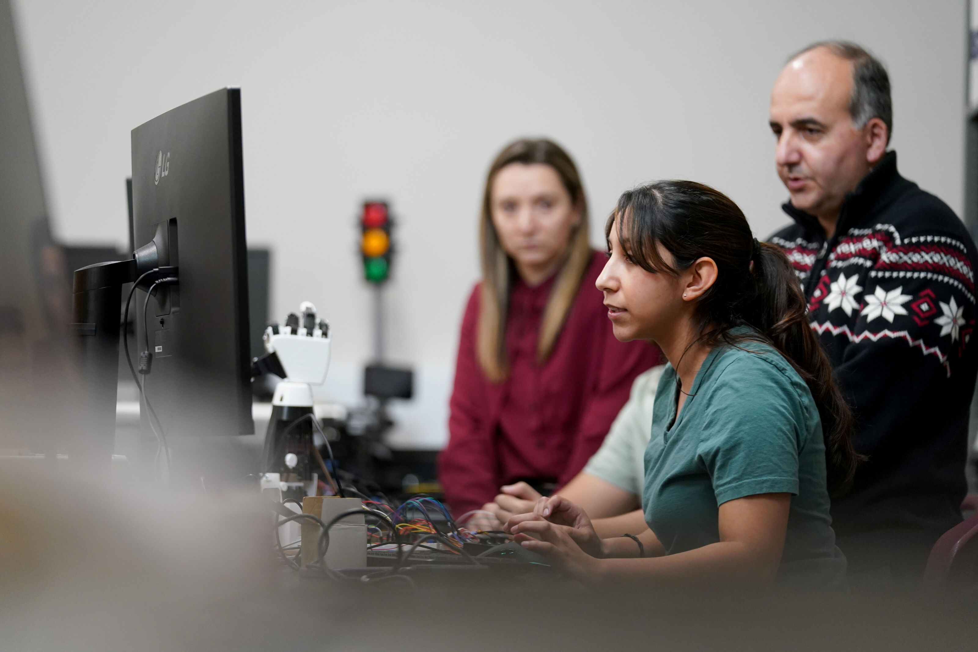 Pillar 4 Three people looking at a computer screen